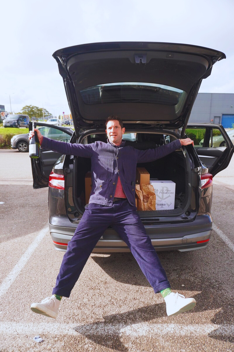 Ben McFarland with his boot full of wine crates